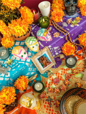 flowers, candles, photos and other decorations for Dia de los Muertos